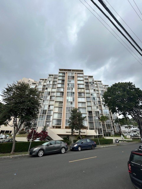 A grey building with a white sign on it.